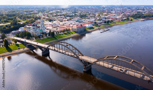 Drone view of the small Russian city of Rybinsk with the longest and original bridge over the Volga River on a summer day