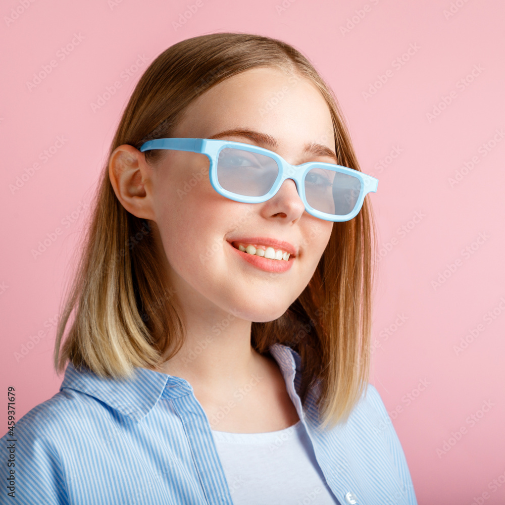 Smiling teenager girl portrait movie viewer in glasses isolated over pink color background with copy space. Young woman in cinema glasses for watching 3d movie in cinema. Closeup square portrait
