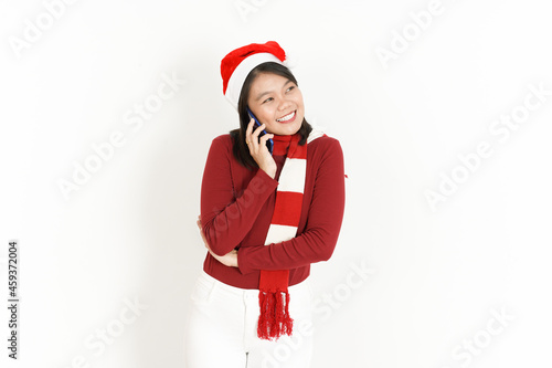 Talking on the phone with happy face expression of Beautiful Asian Woman Wearing Red Turtleneck and Santa Hat Isolated On White Background