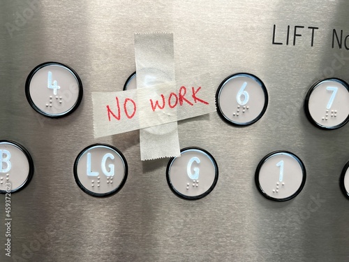 A no work sign on the buttons of an out of service lift elevator 