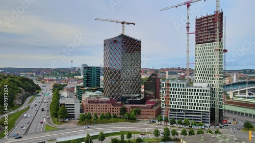 Traffic Driving In The Road Passing By Citygate And Kineum High-rise Building Under Construction In Gothenburg, Sweden. - aerial photo