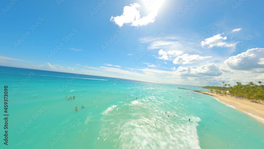 FPV drone shot over people sun bathing and swimming in turquoise sea of Caribbean - aerial POV view FPV drone shot over people sun bathing and swimming in turquoise sea of Caribbean - aerial POV view
