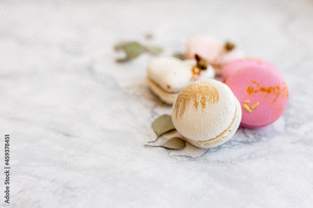 Macaroons close up. Pink and white macaroons on the murble table Macaroons close up. Pink and white macaroons on the murble table