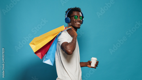 Canvas-taulu Happy man with handbags dancing after shopping spree