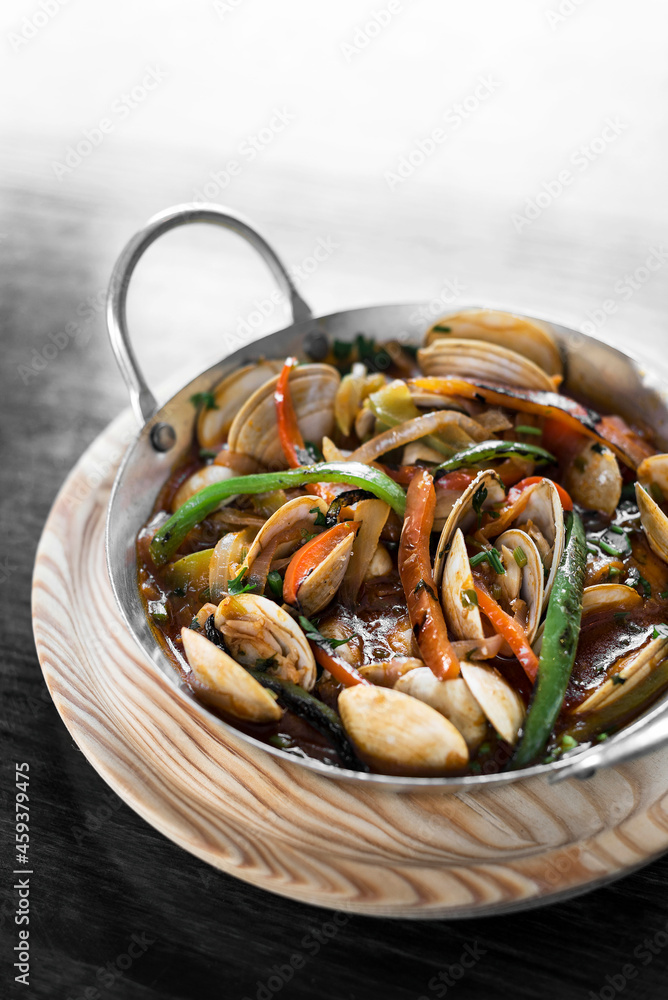 mediterranean clam and vegetable stew in pot at barcelona restaurant mediterranean clam and vegetable stew in pot at barcelona restaurant