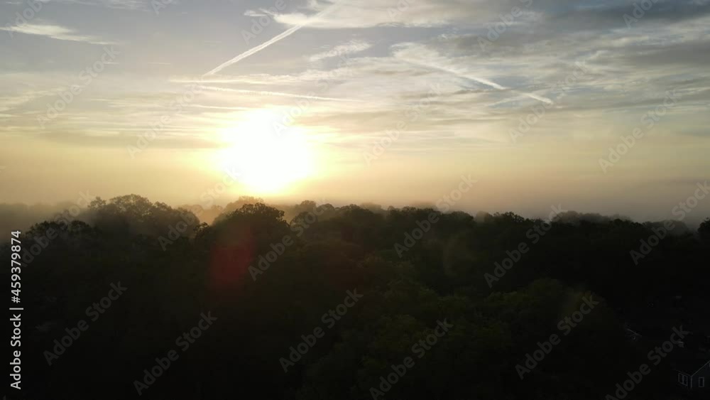 A drone rising through foggy cloud cover to reveal a sunrise. 4k 30fps A drone rising through foggy cloud cover to reveal a sunrise. 4k 30fps