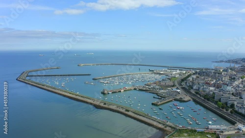 Dún Laoghaire Harbour as seen from Seapoint, Monkstown, Dublin, Ireland, September 2021. Drone pushes along the west pier with Dublin bay in the distance. photo