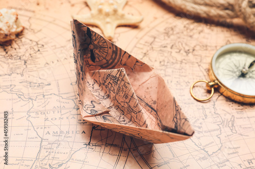 Paper boat on vintage world...