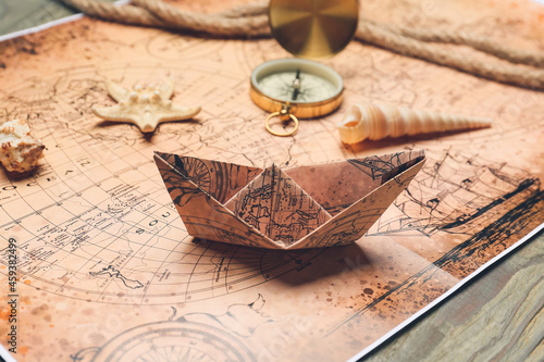 Paper boat on vintage world...