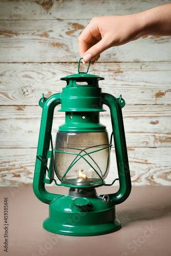 Woman holding retro lamp on...