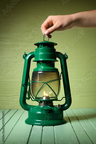 Woman holding retro lamp on...