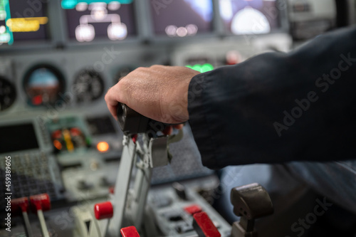 Engine thrust levers. The pilot's hand holds the levers.