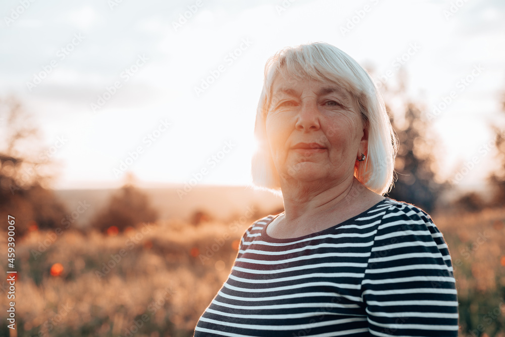Caucasian woman at sunset in the field. Summer vacation, enjoying the sun. Horizontal banner Caucasian woman at sunset in the field. Summer vacation, enjoying the sun. Horizontal banner