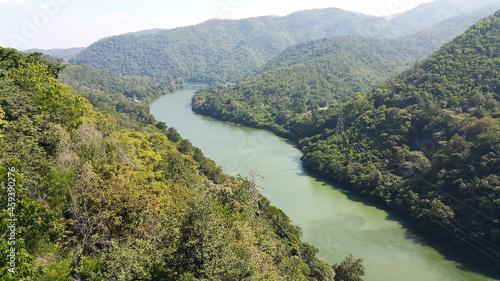 Scenic high-angle view of a winding river through a lush mountain valley