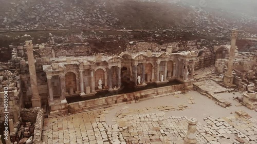 View of ruins of antique Nymphaeum of Sagalassos ancient city, Turkey, in foggy winter day photo