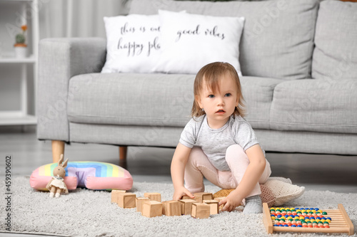 Cute baby girl playing at home