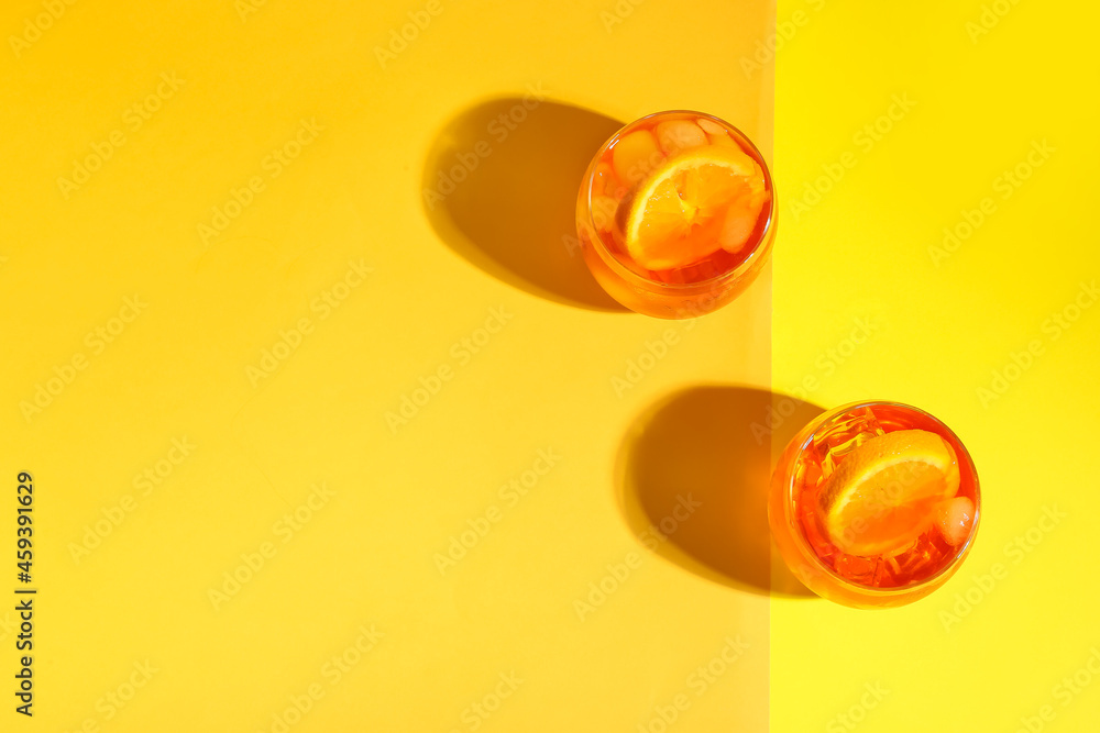 Glasses of Aperol spritz cocktail on color background Glasses of Aperol spritz cocktail on color background
