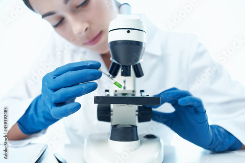 woman laboratory assistant microscope research biotechnology science