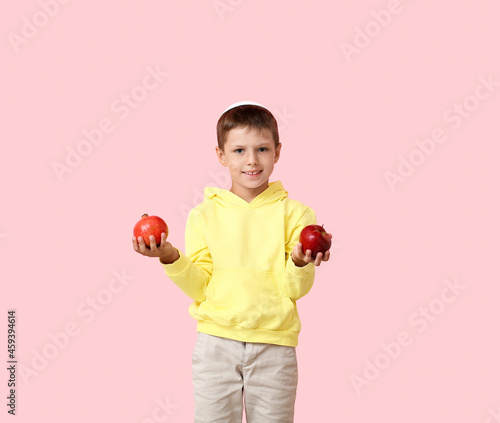 Little boy with pomegranate...