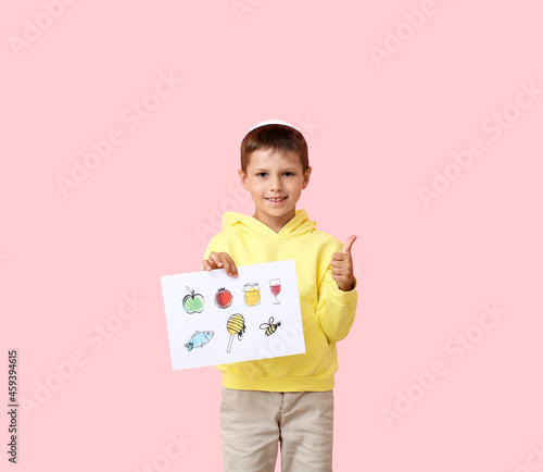 Little boy holding paper wi...