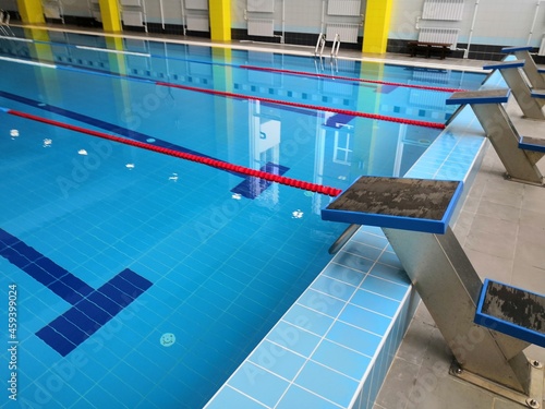 a large, clean and new swimming pool in the educational institution. Swimming tracks and clear water, everything is ready for the competition. Curbstones, pedestals for diving into the water