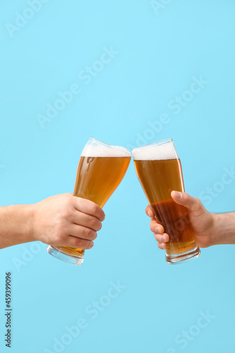 Hands with glasses of beer ...
