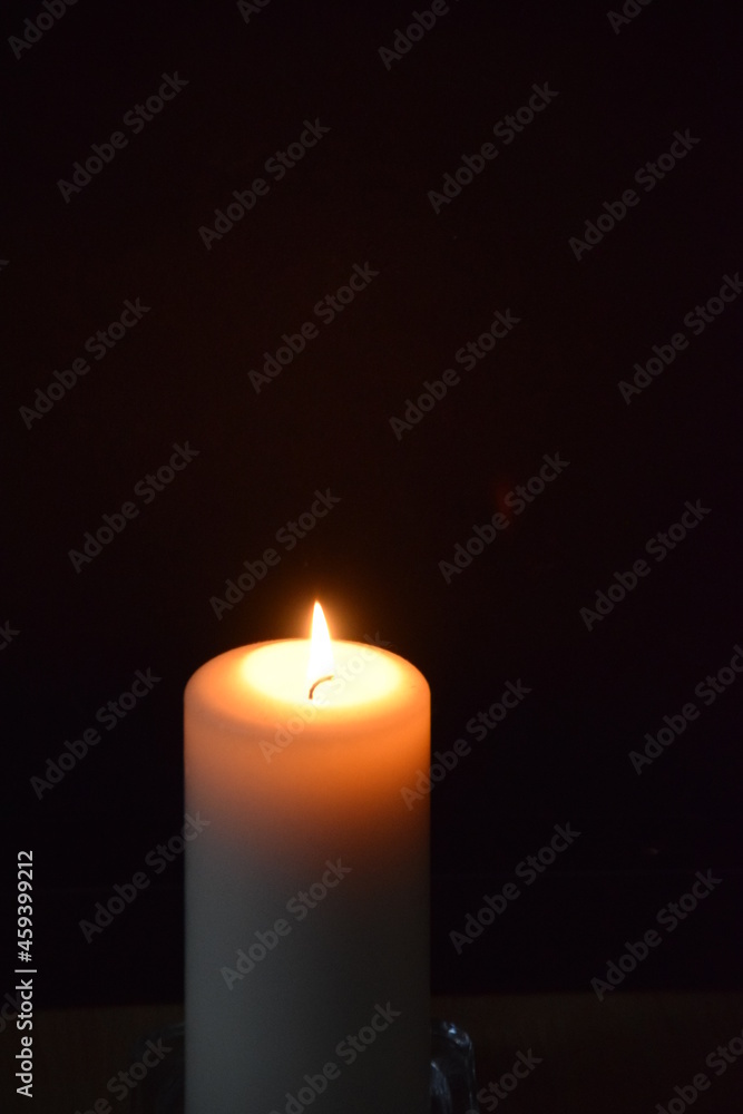 Burning candle with black background Burning candle with black background