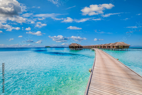 Maldives paradise scenery. Tropical aerial landscape, seascape with long jetty, water villas with amazing sea and lagoon beach, tropical nature. Exotic tourism destination banner, summer vacation © icemanphotos