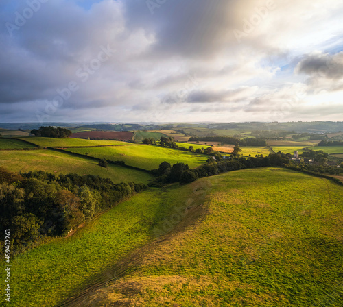 Sunset over the fields from drone, Berry Pomeroy Village, Devon, England, Europe photo