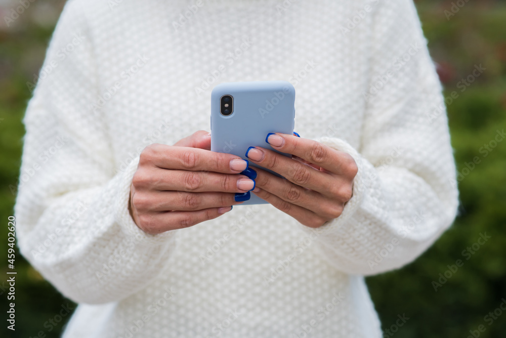 Close up image with female hands using a smartphone. Close up image with female hands using a smartphone.