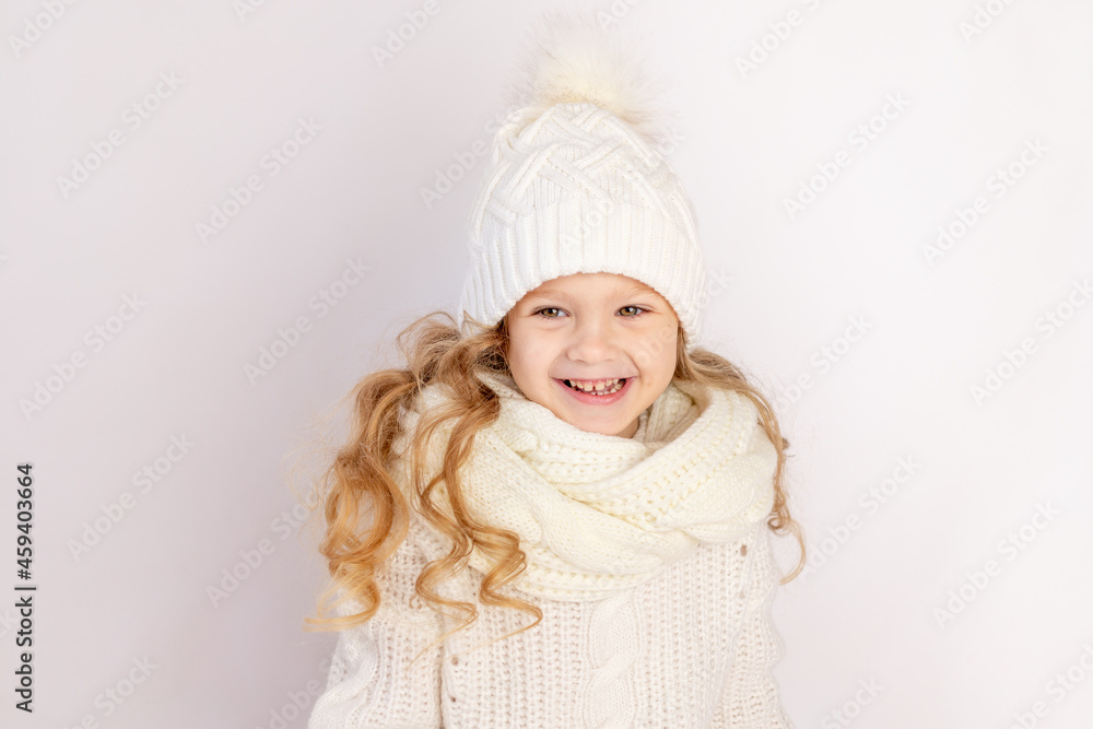 happy baby girl in warm hat and sweater on white isolated background, space for text happy baby girl in warm hat and sweater on white isolated background, space for text
