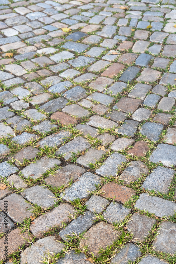 road made with granite cobblestone. natural stone parquet.