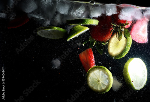 Water drops on ripe sweet fruits and berry. Fresh fruits background with copy space for your text. Vegan concept.