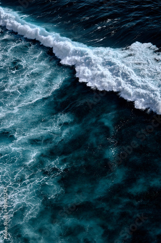 Aerial view to waves in ocean Splashing Waves. Blue clean wavy sea water. © Dmitry Yakovtsev