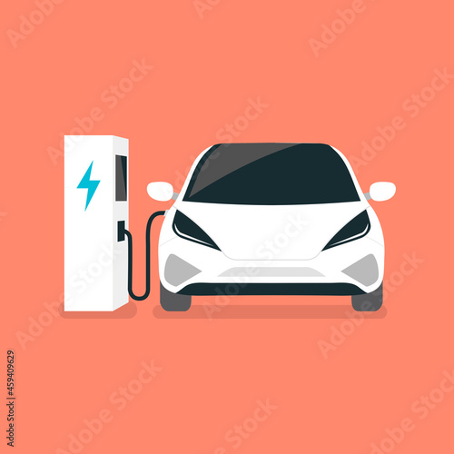 Modern electric car charges on an electric vehicle EV charging station point.