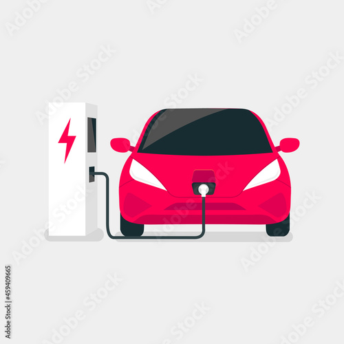 Modern electric car charges on an electric vehicle EV charging station point.