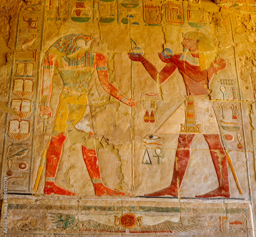 The painting of the Egyptian gods, Set (left) and Horus (right) engraved on the inside wall of the Abu Simbel great temple in Aswan, Egypt