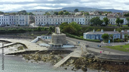 Martello Tower, Seapoint, Monkstown, Dublin, Ireland, September 2021. Drone gradually orbits the tower while ascending above Brighton Vale terrace with the view east along the coastline. photo