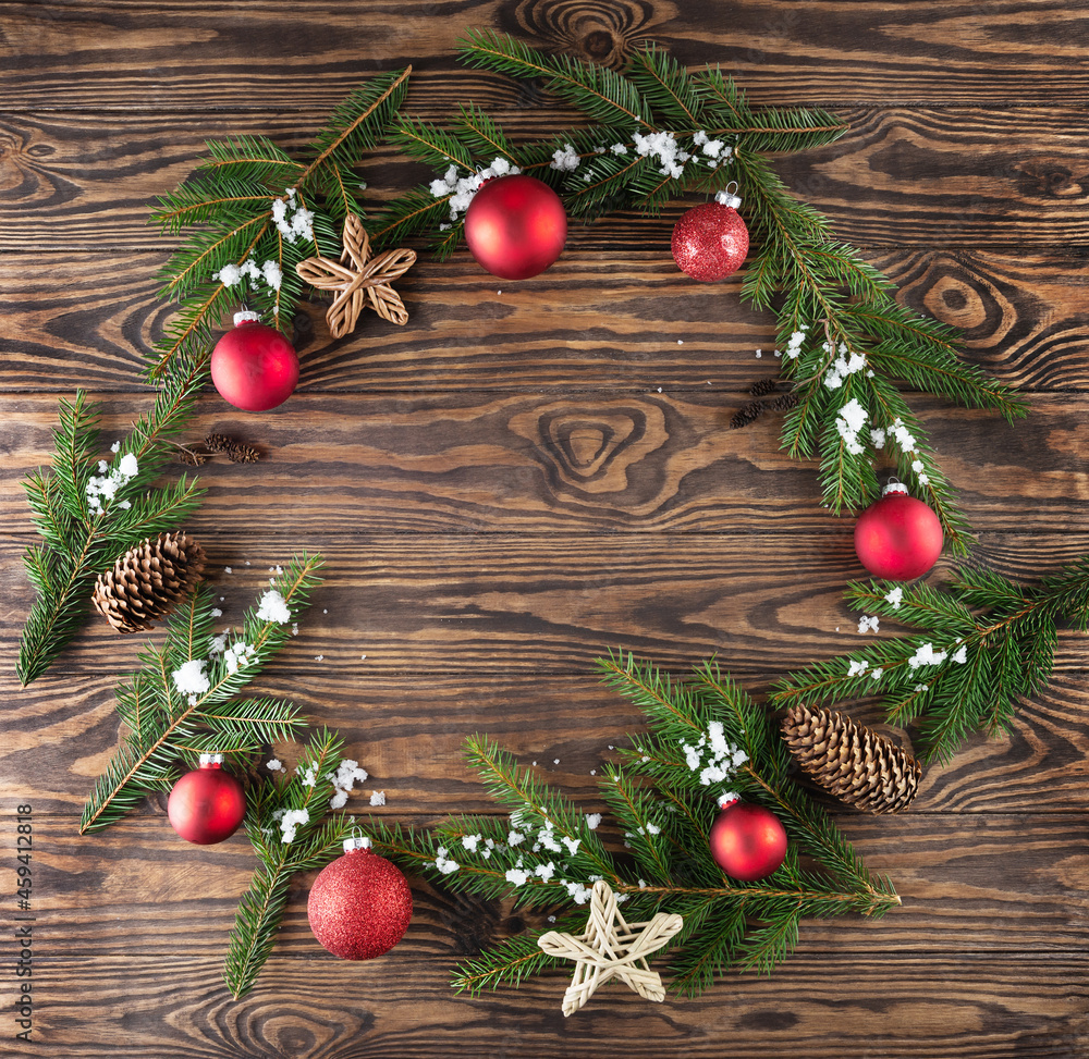 Wreath of Christmas tree branches, ornaments on a wooden background. Christmas and New Year concept. Horizontal orientation, copy space, top view. Wreath of Christmas tree branches, ornaments on a wooden background. Christmas and New Year concept. Horizontal orientation, copy space, top view.