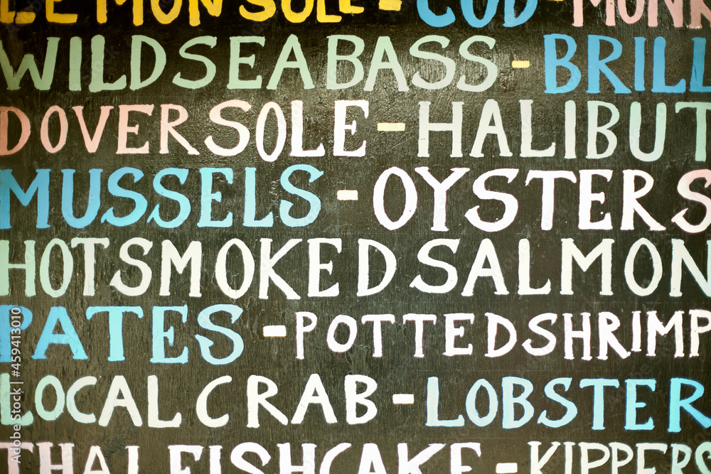 Hand painted sign listing seafood items Hand painted sign listing seafood items