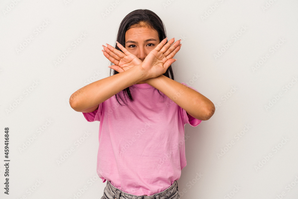 Young latin woman isolated on white background doing a denial gesture Young latin woman isolated on white background doing a denial gesture