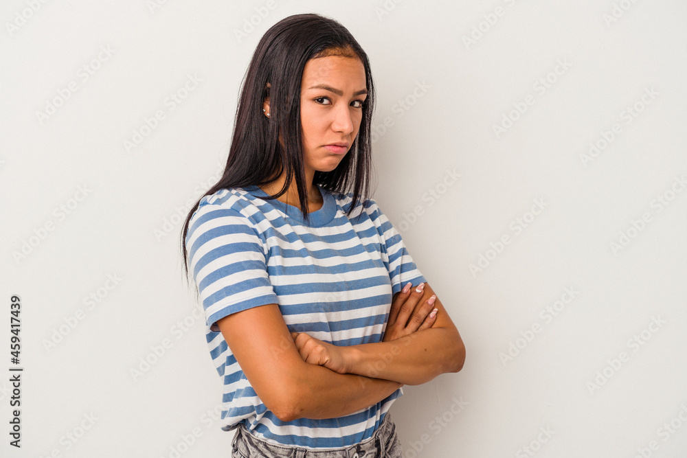 Obraz premium Young latin woman isolated on white background suspicious, uncertain, examining you.