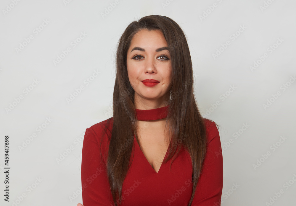 Portrait of a beautiful smiling young girl in red dress