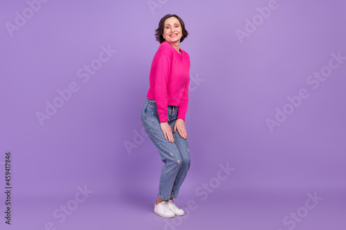 Full length profile side photo of attractive aged woman happy positive smile casual outfit isolated over purple color background