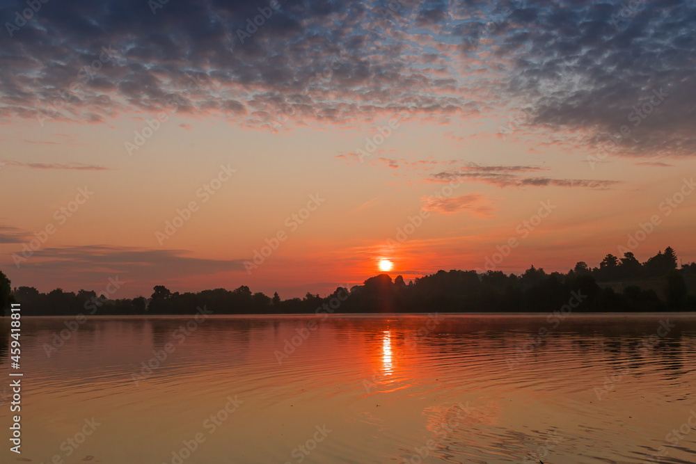 Morning lake in calm weather during sunrise Morning lake in calm weather during sunrise