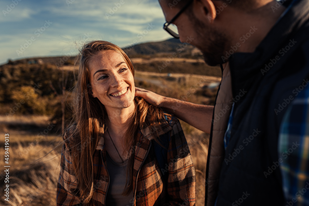 Couple hiking together in nature with backpacks at sunset. Couple hiking together in nature with backpacks at sunset.