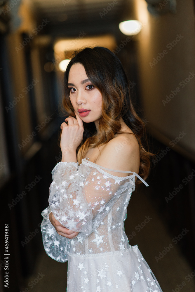 Naklejka premium Young stylish asian woman in white dress, vintage style, natural, innocent, smiling in hotel