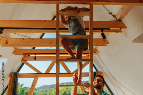 Girl climbing ladder at home