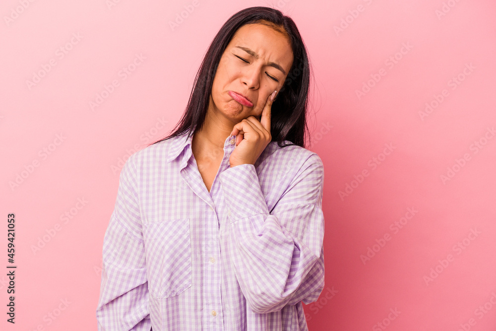Young latin woman isolated on pink background crying, unhappy with something, agony and confusion concept. Young latin woman isolated on pink background crying, unhappy with something, agony and confusion concept.