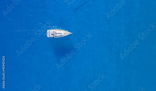 sailing vessel sailing in a clear crystal water in ibiza in the mediterranean sea